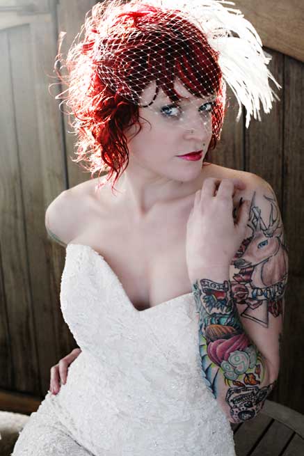 Second, she's wearing a birdcage veil with feathers.