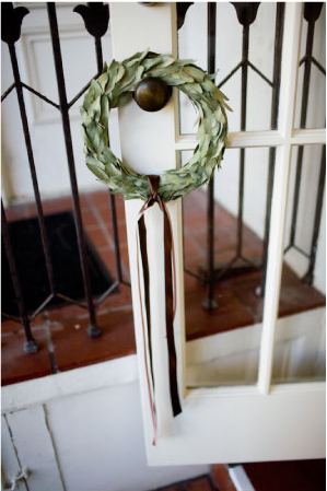green leaf wreath with brown ribbon