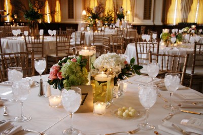 pink white and green centerpiece with candles