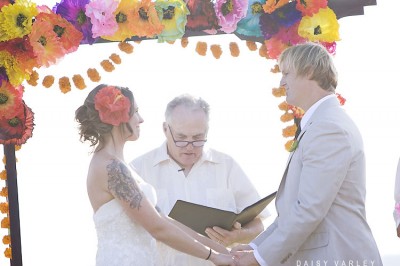 wedding-under-colorful-tissue-paper-flower-arch wedding-under-colorful-tissue-paper-flower-arch