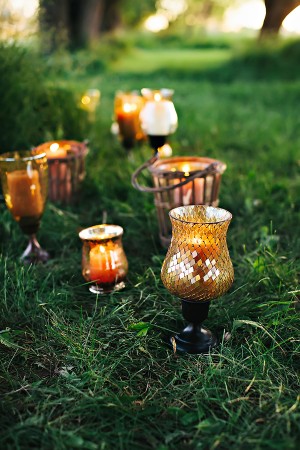 Candles in Amber Colored and Mosaic Vases Sitting on Grass1