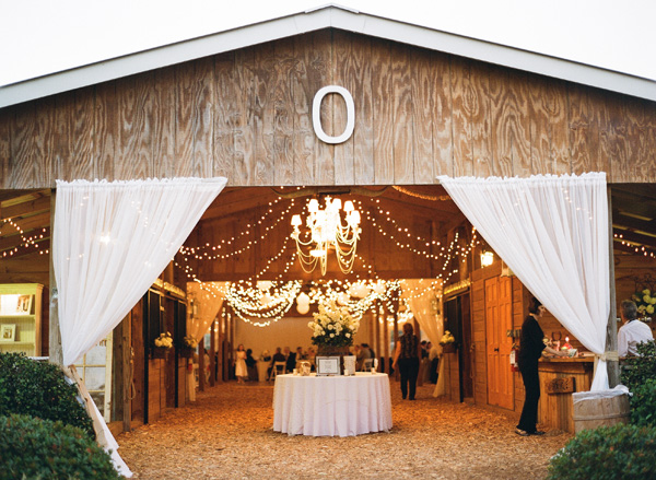 Barn Reception With Sheer Curtains and Chandelier